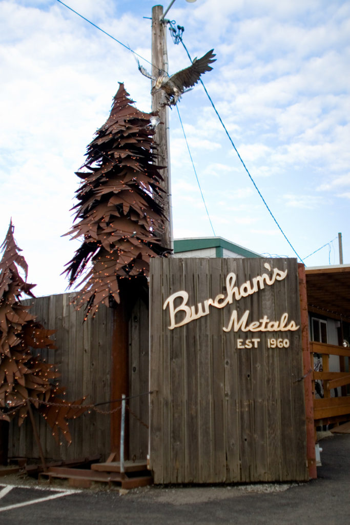 Burcham’s Metals wooden fence with metal tree